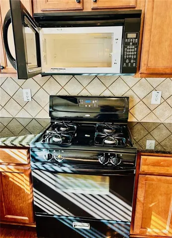 a stove top oven sitting inside of a kitchen