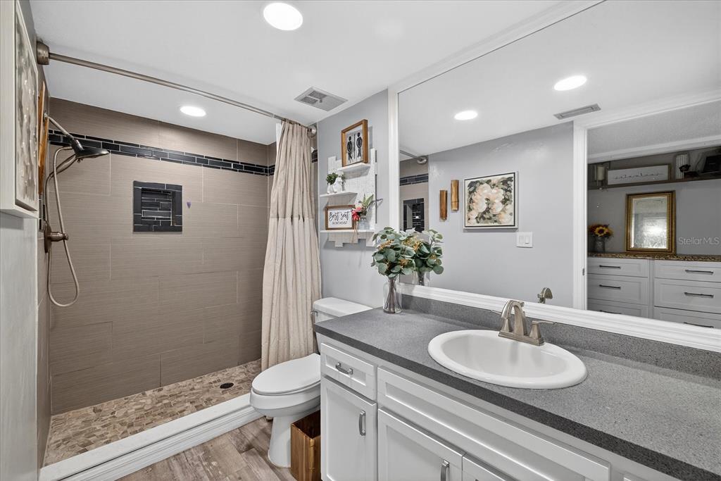 3230 Teeside Drive New Port Richey, FL 34655 - Photo 15 of 32 a bathroom with a granite countertop sink toilet and shower