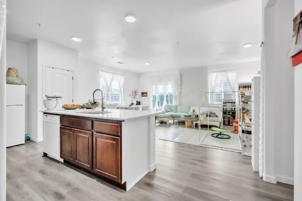 a kitchen with stainless steel appliances granite countertop a sink stove and cabinets