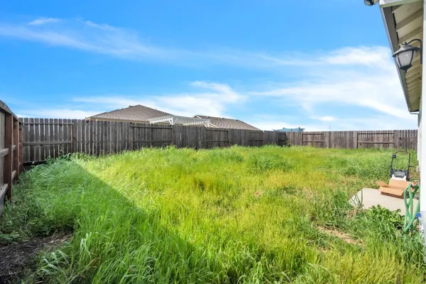 a view of a house with yard and a garden
