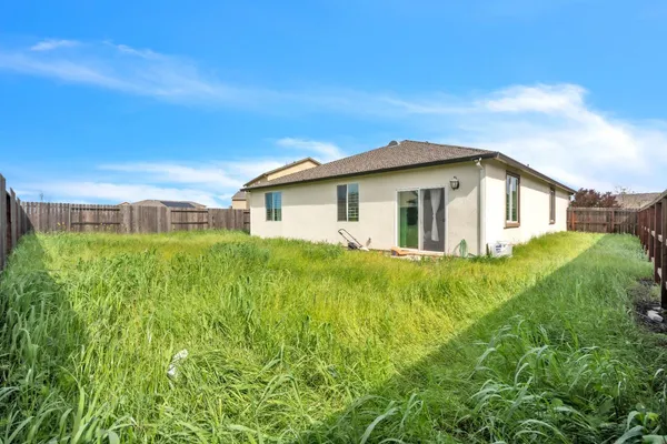 an aerial view of a house with a garden and swimming pool