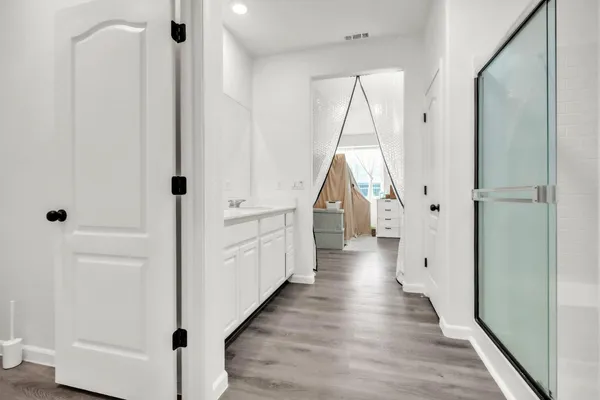 a view of a hallway view with wooden floor and staircase
