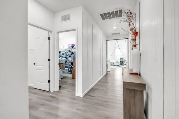 a view of a hallway with wooden floor