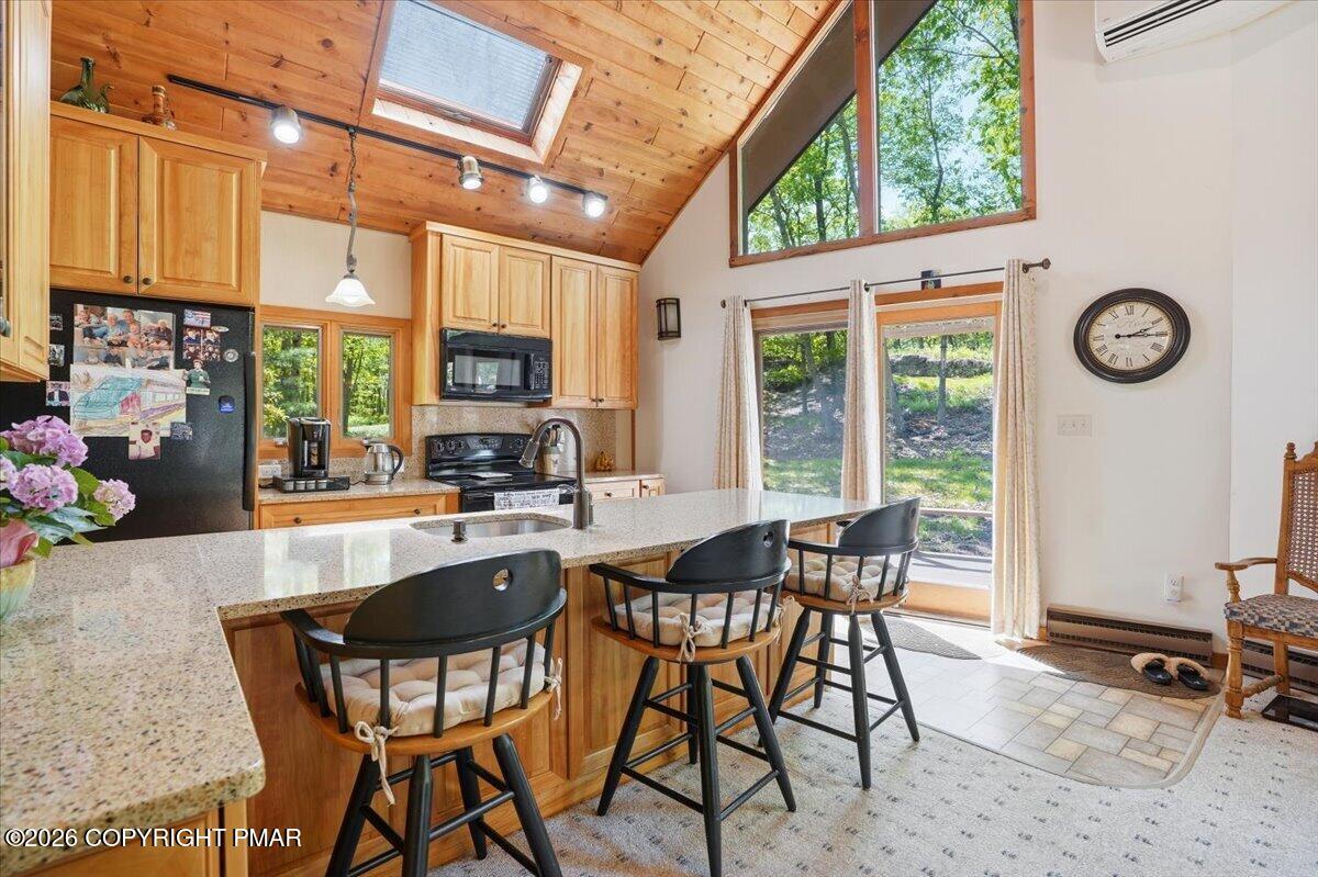 1517 Deer Run East Bushkill, PA 18324 - Photo 18 of 42 a kitchen with a table chairs and a stove
