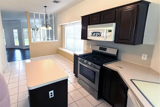 a kitchen with a sink cabinets and window