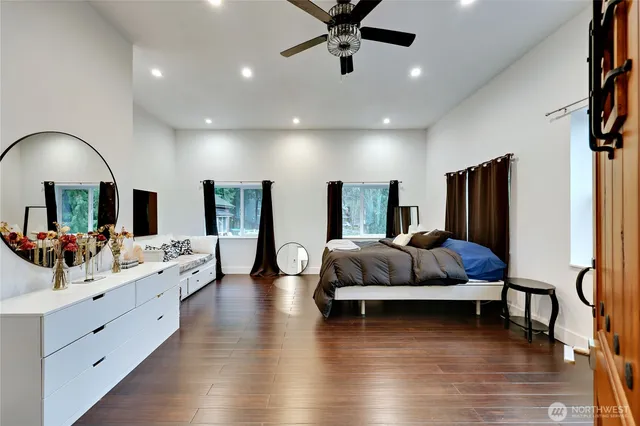 a living room with furniture ceiling fan and a wooden floor