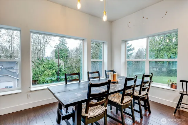 a view of a dining room with furniture and wooden floor