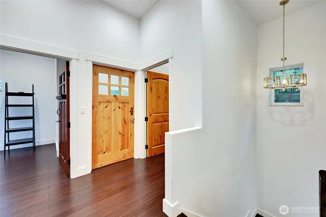 a view of a room with wooden floor and windows