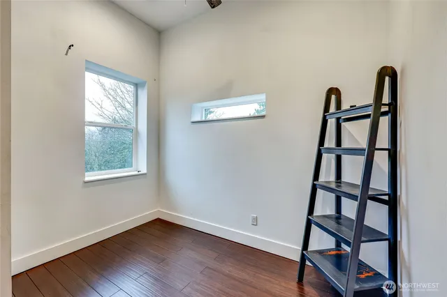 a view of staircase with wooden floor and a window