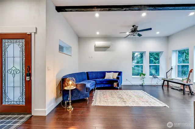 a living room with furniture and a wooden floor