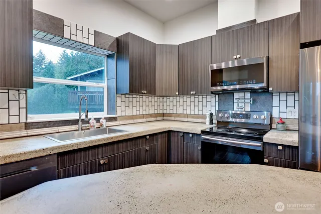 a kitchen with a sink stove and microwave