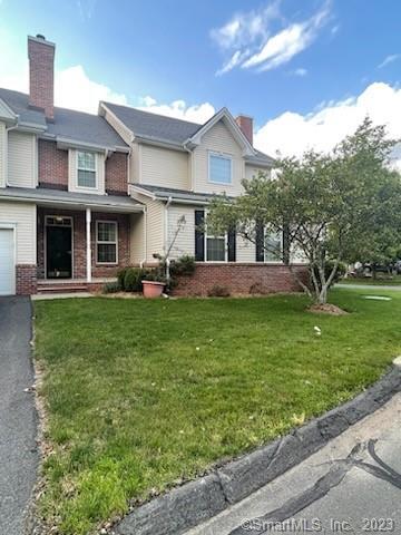 a front view of a house with a garden and plants
