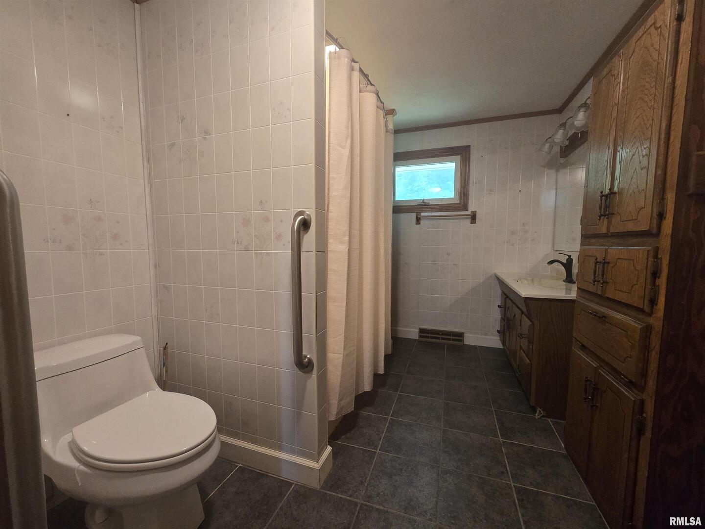 507 South Church Street Albany, IL 61230 - Photo 11 of 15 a bathroom with a sink toilet and shower