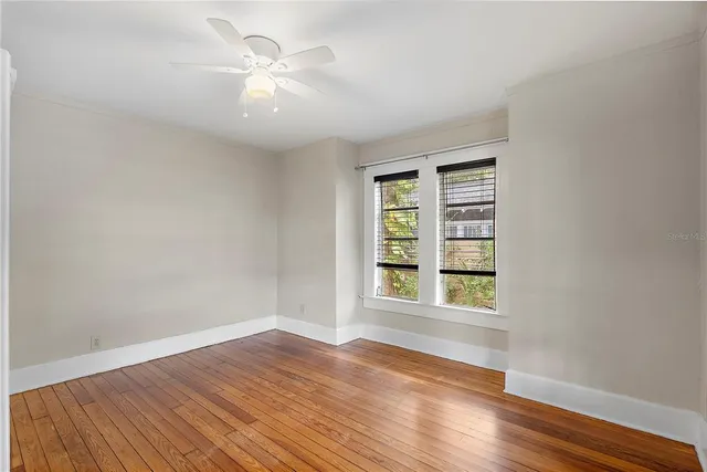 wooden floor in an empty room with a window