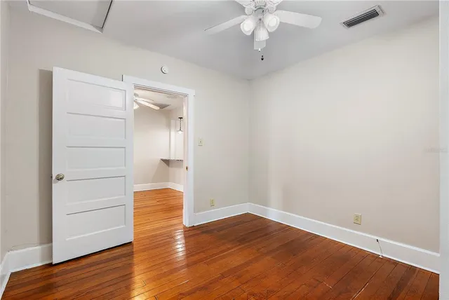 a kitchen with stainless steel appliances granite countertop a refrigerator a sink dishwasher a stove with white cabinets and wooden floor