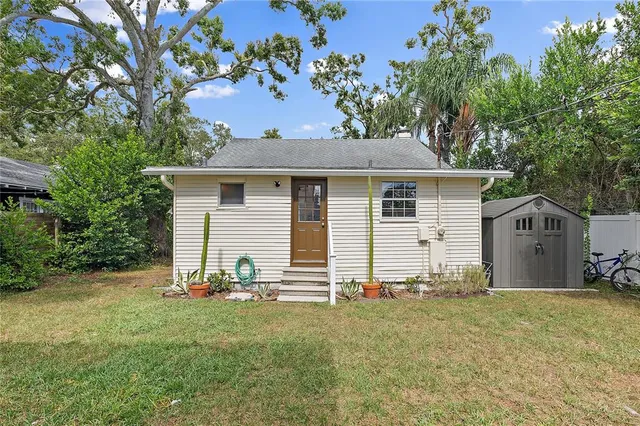 a view of a house with a yard and a patio