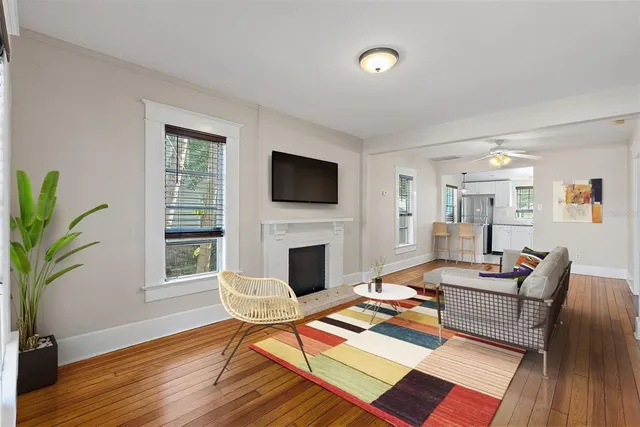 a living room with furniture wooden floor and a fireplace