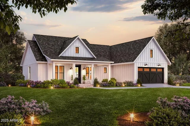 a front view of a house with a garden and plants
