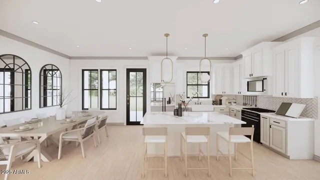 a dining hall with stainless steel appliances kitchen island granite countertop a dining table chairs and view living room