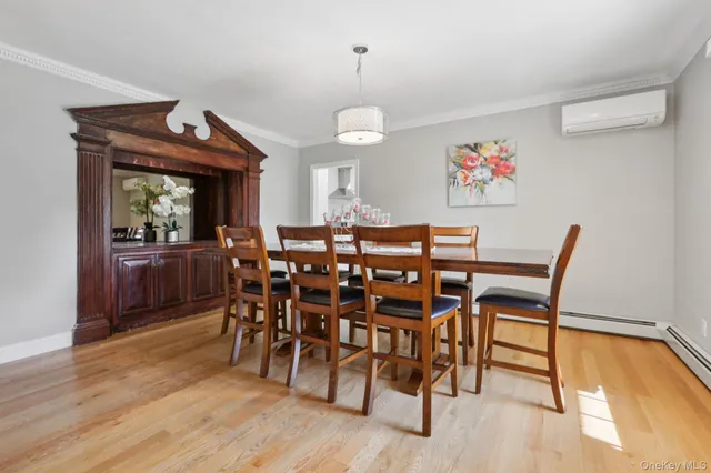 a view of a dining room with furniture a chandelier and wooden floor