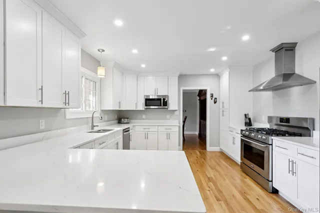 a dining area with stainless steel appliances kitchen island granite countertop a dining table chairs and granite counter tops