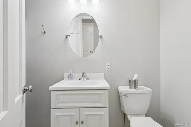 a white toilet sitting next to a bathroom sink
