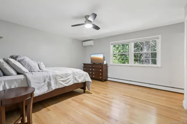 a bathroom with a granite countertop sink toilet a mirror and shower