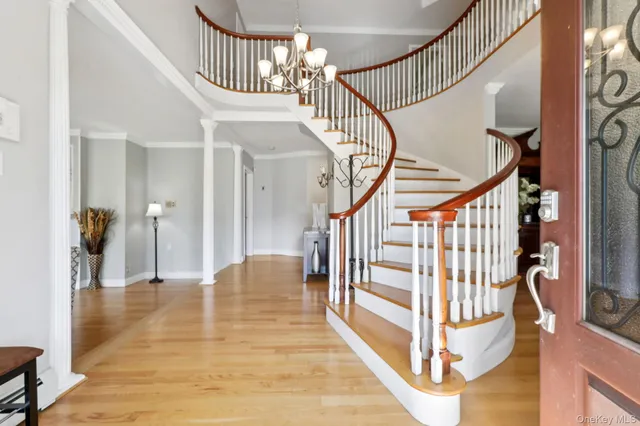 a view of entryway and hall with wooden floor
