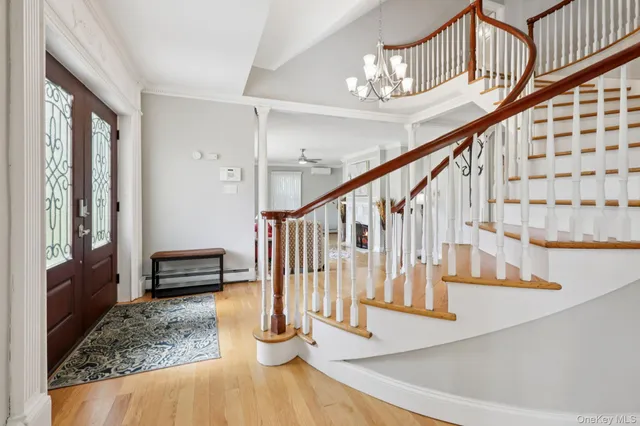 a view of entryway and hall with wooden floor