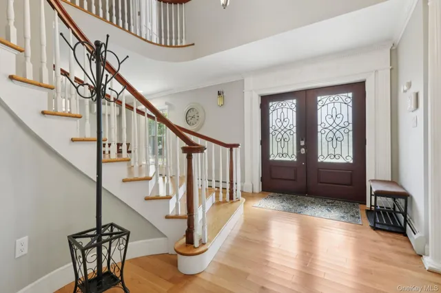 a view of entryway and hall with wooden floor