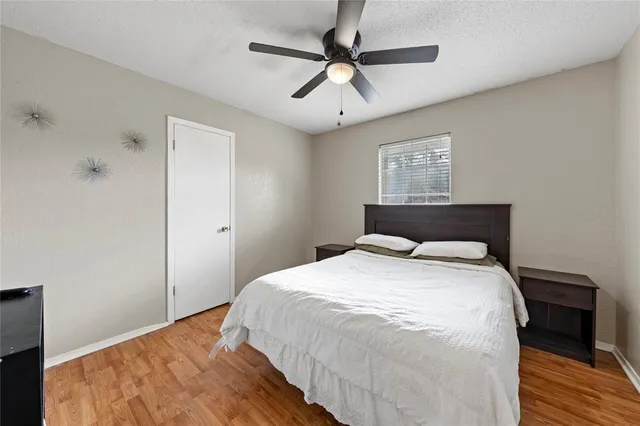 a bedroom with a bed and a ceiling fan