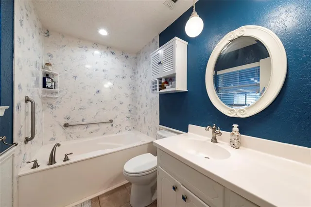 a bathroom with a bathtub a sink and a mirror