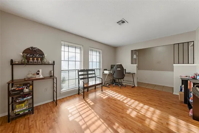 a living room with furniture a piano and a window