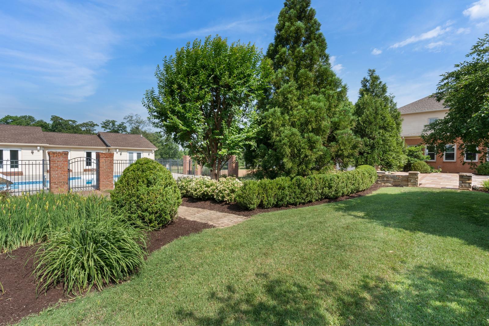 11363 Owens Chapel Road Springfield, TN 37172 - Photo 29 of 30 a view of a garden with a building in the background