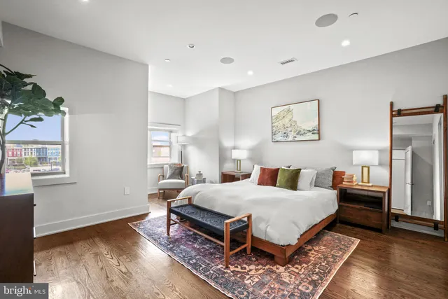 a bedroom with a bed and wooden floor