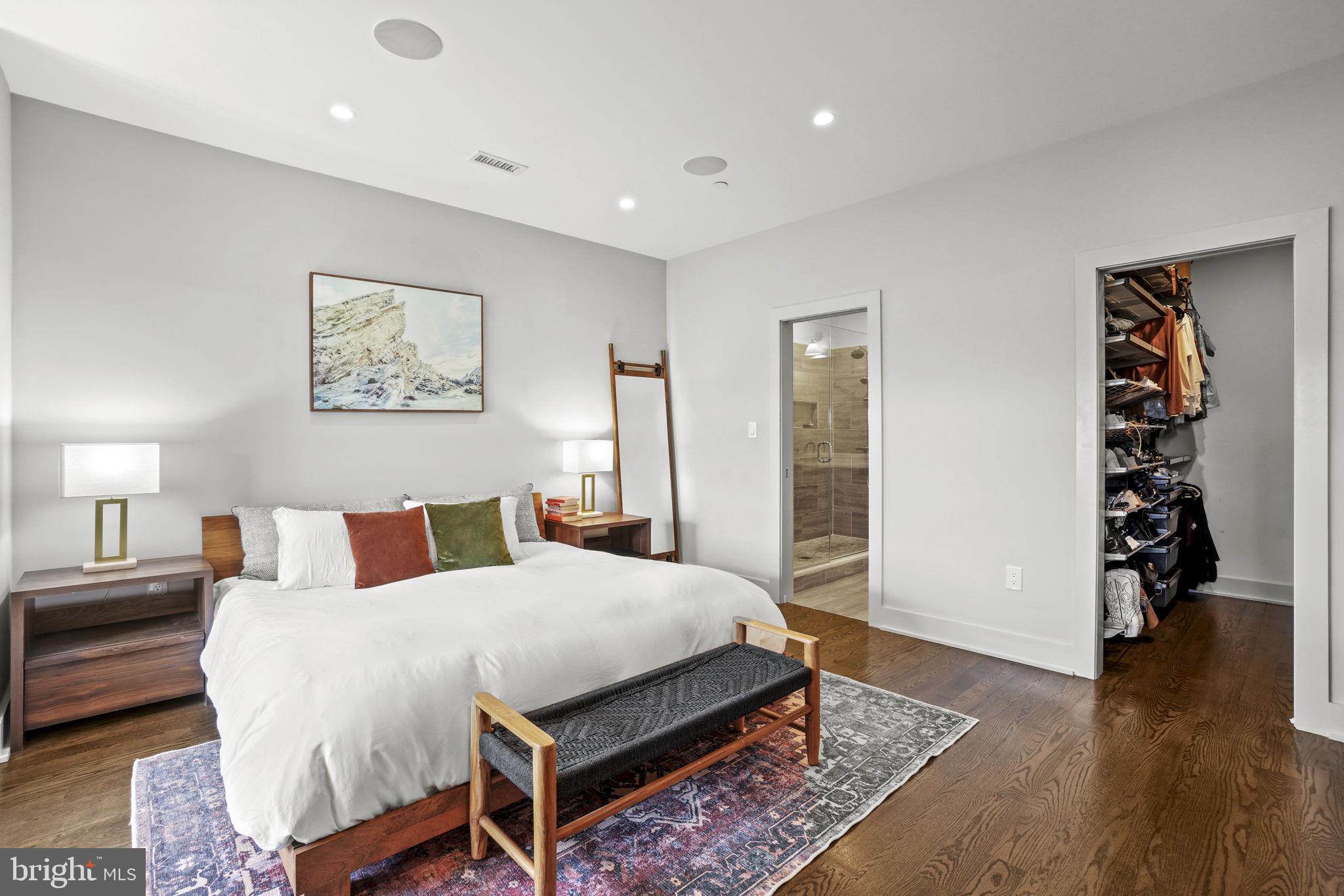 1201 Kenyon Street Northwest, Unit 5 Washington, DC 20010 - Photo 14 of 35 a spacious bedroom with a bed a dresser and wooden floor