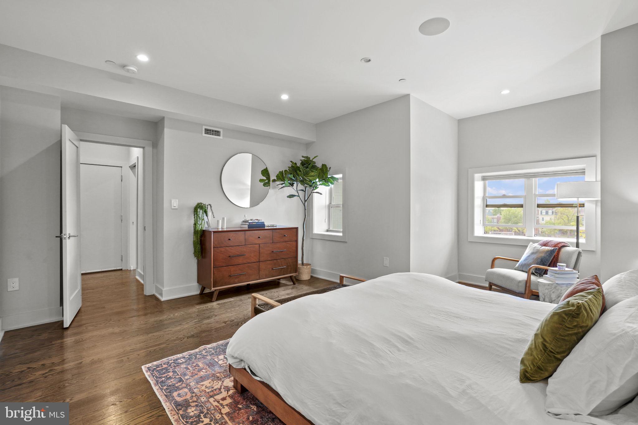 1201 Kenyon Street Northwest, Unit 5 Washington, DC 20010 - Photo 15 of 35 a bedroom with a bed a mirror and furniture