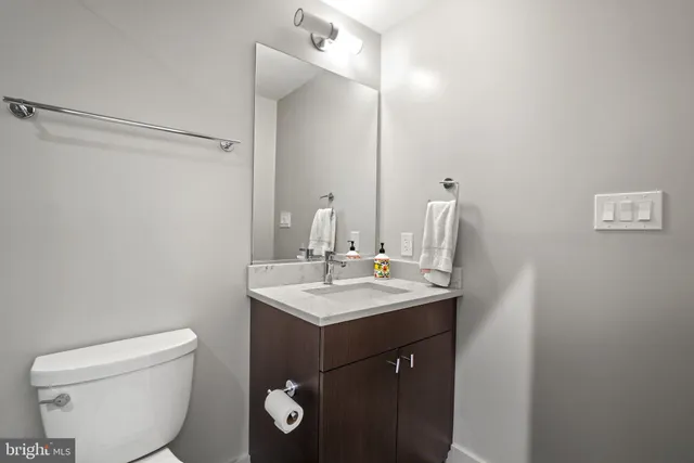 a bathroom with a toilet sink and mirror