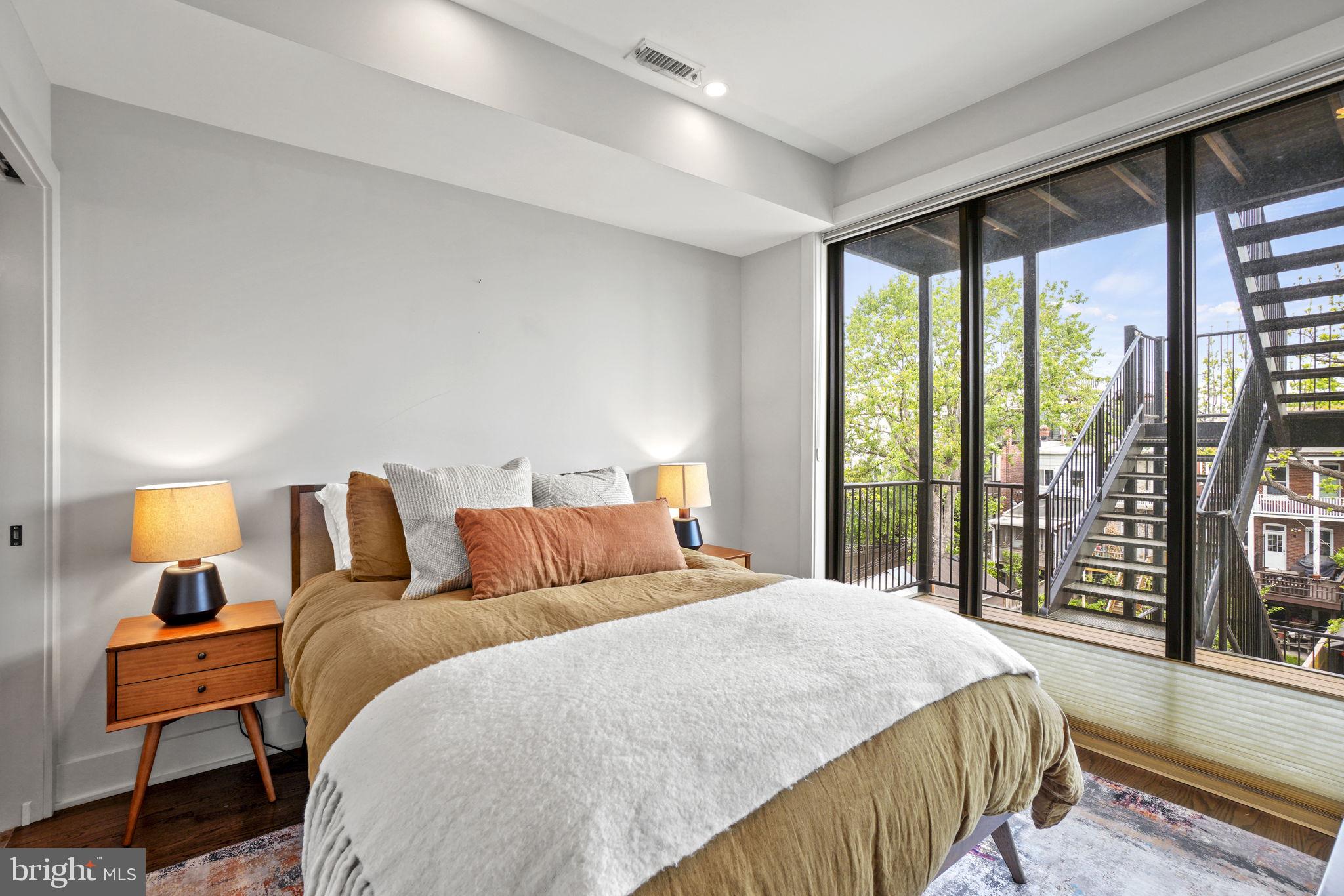 1201 Kenyon Street Northwest, Unit 5 Washington, DC 20010 - Photo 22 of 35 a bedroom with a bed and a large window