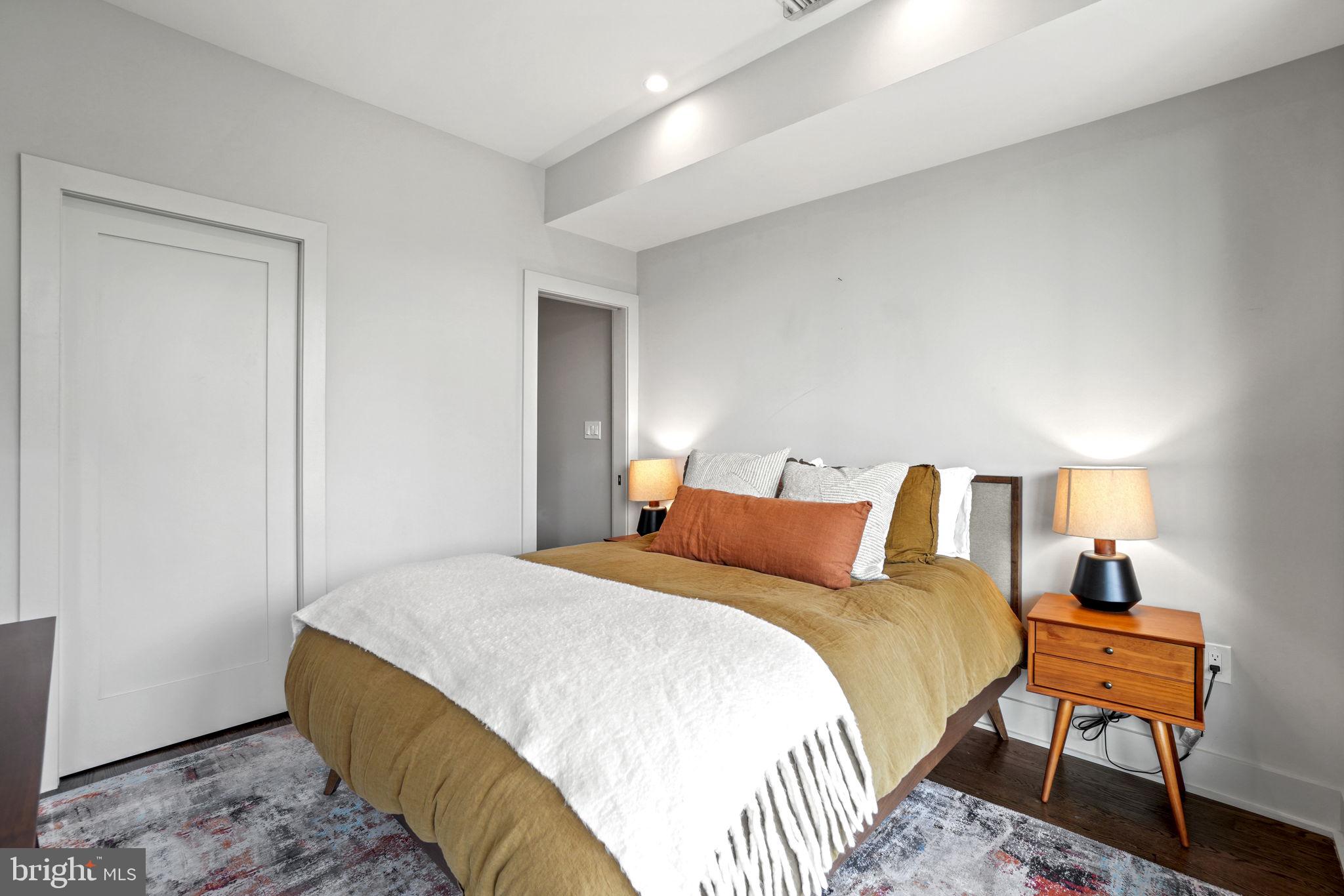 1201 Kenyon Street Northwest, Unit 5 Washington, DC 20010 - Photo 23 of 35 a bedroom with a bed and a lamp