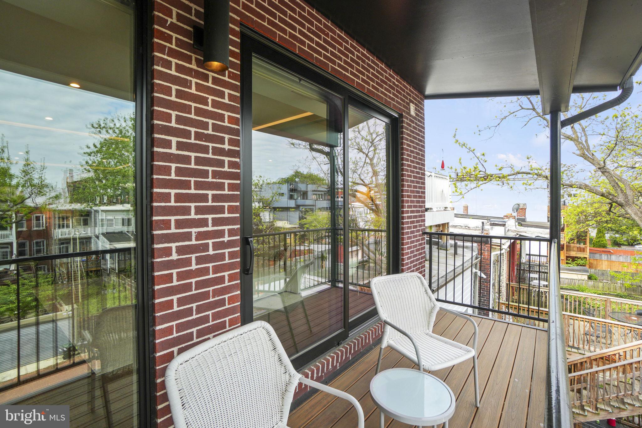1201 Kenyon Street Northwest, Unit 5 Washington, DC 20010 - Photo 26 of 35 a view of a balcony with chairs and a floor to ceiling window