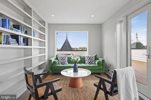 a living room with furniture and a painting
