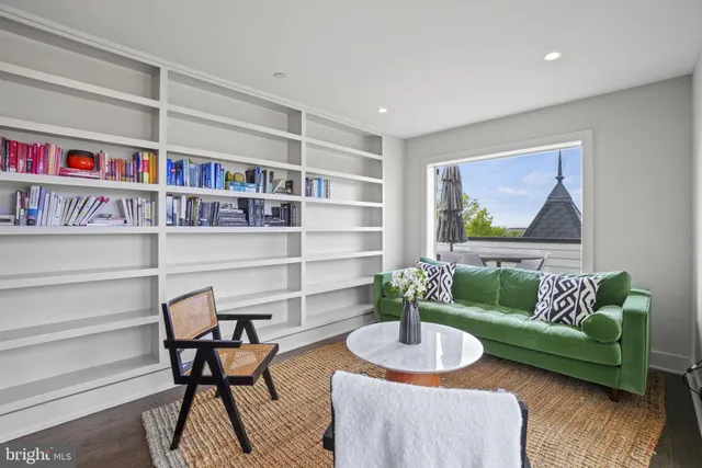 a view of a roof deck with table and chairs a barbeque with wooden floor and fence