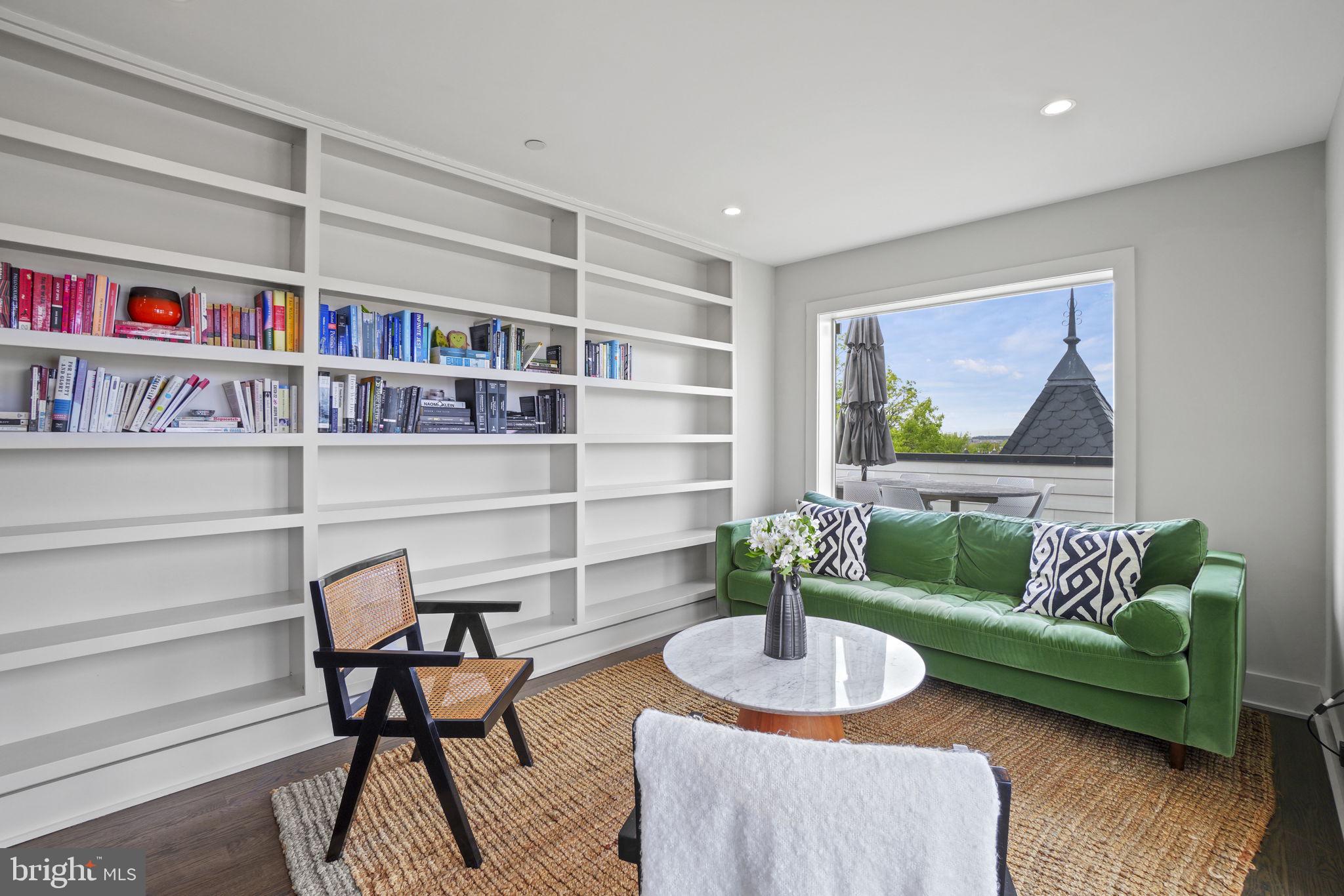 1201 Kenyon Street Northwest, Unit 5 Washington, DC 20010 - Photo 33 of 35 a living room with furniture and a book shelf