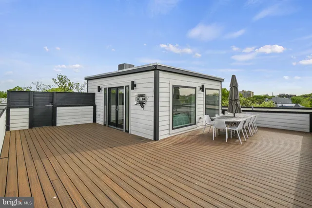 a patio with wooden floor and city view