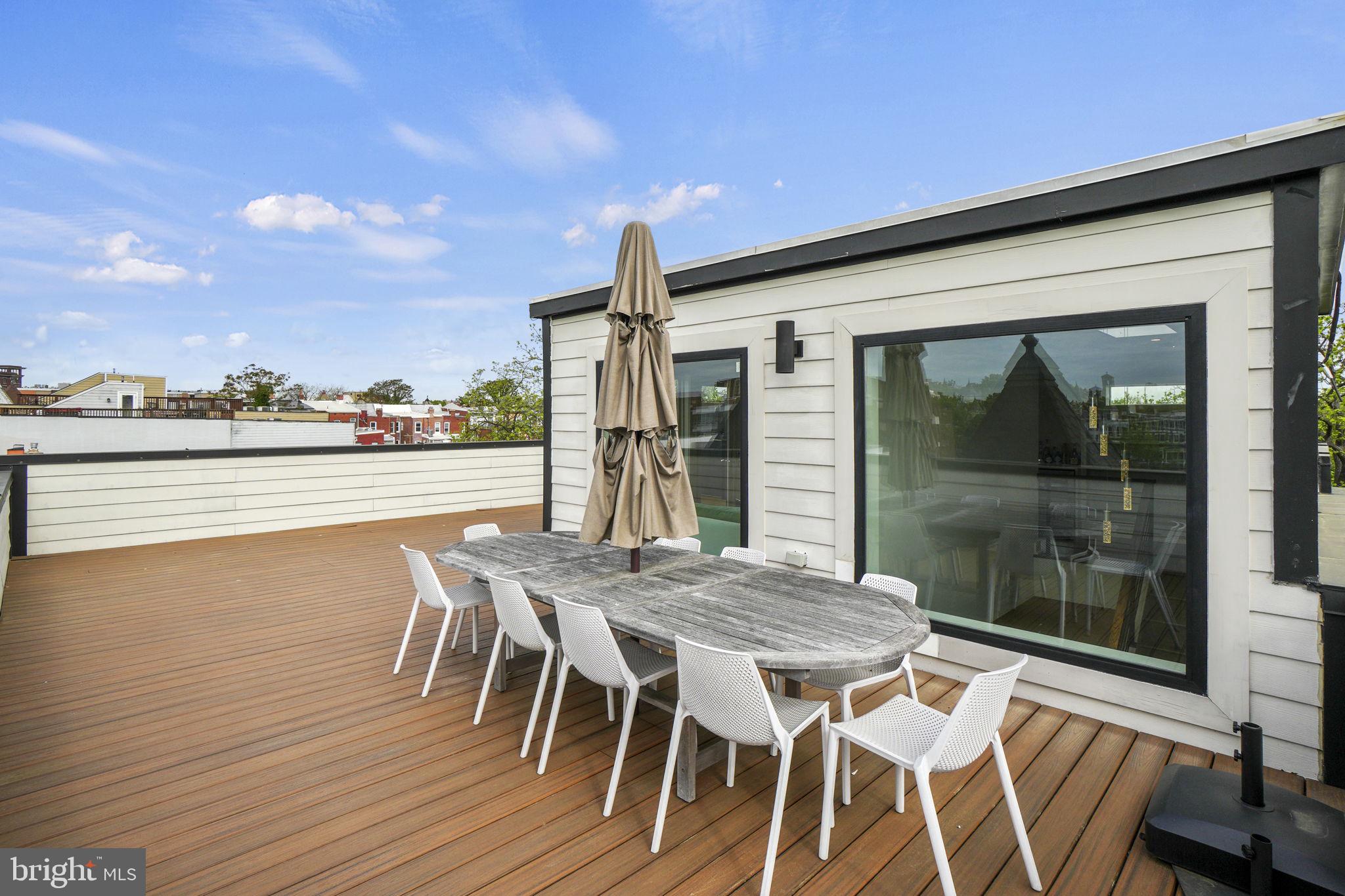 1201 Kenyon Street Northwest, Unit 5 Washington, DC 20010 - Photo 35 of 35 a patio with wooden floor and city view