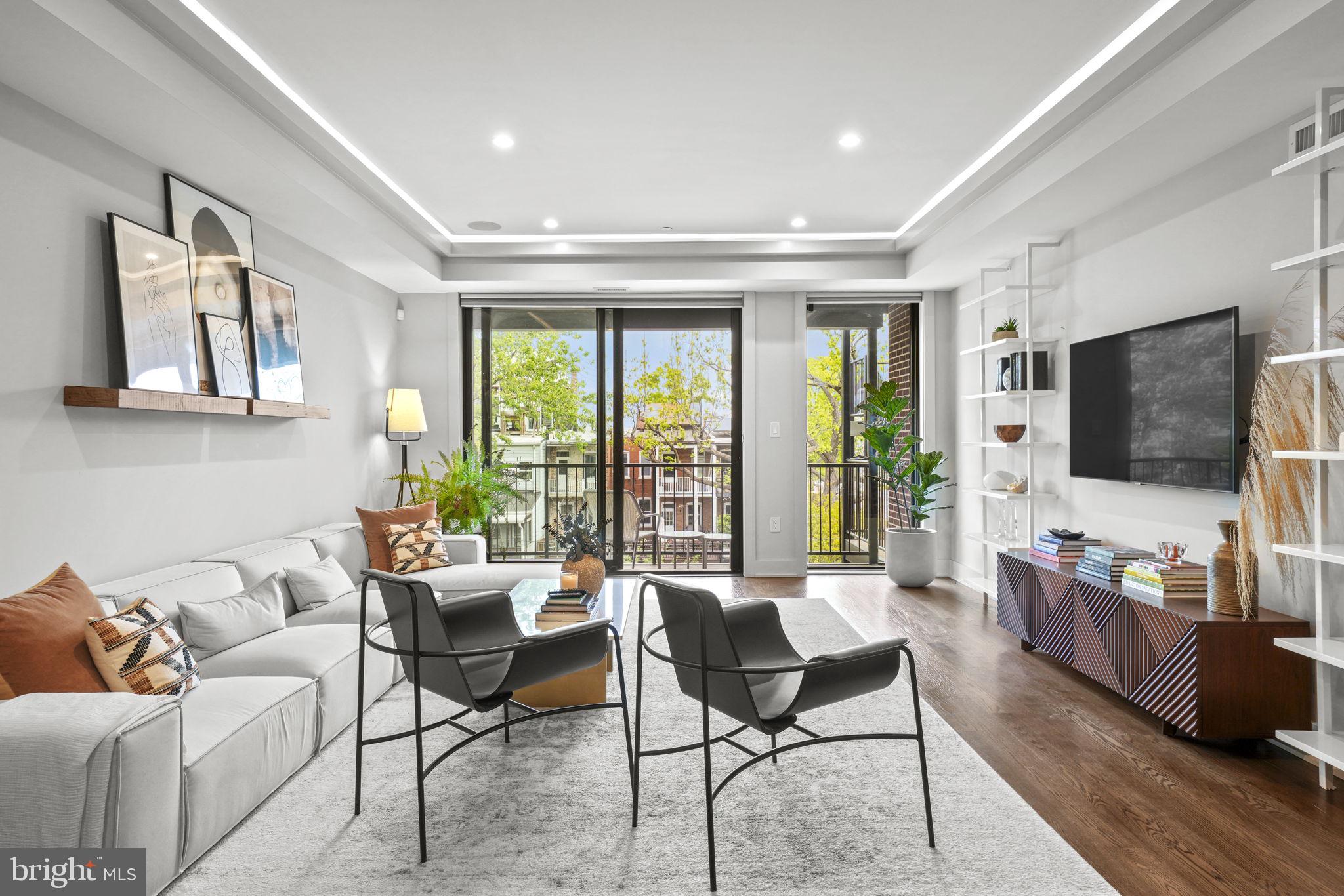 1201 Kenyon Street Northwest, Unit 5 Washington, DC 20010 - Photo 5 of 35 a living room with furniture and a flat screen tv
