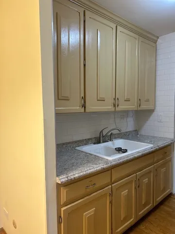 a kitchen with granite countertop cabinets and stainless steel appliances