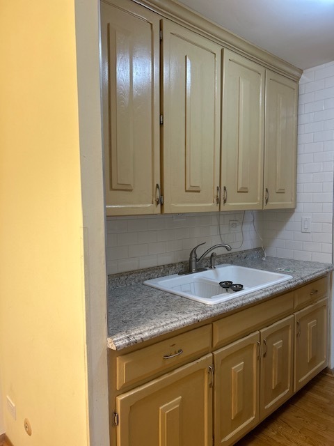 5915 West Gunnison Street, Unit 2F Chicago, IL 60630 - Photo 3 of 10 a kitchen with granite countertop cabinets and stainless steel appliances