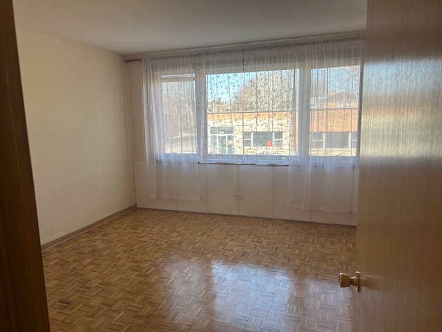 5915 West Gunnison Street, Unit 2F Chicago, IL 60630 - Photo 6 of 10 an empty room with windows